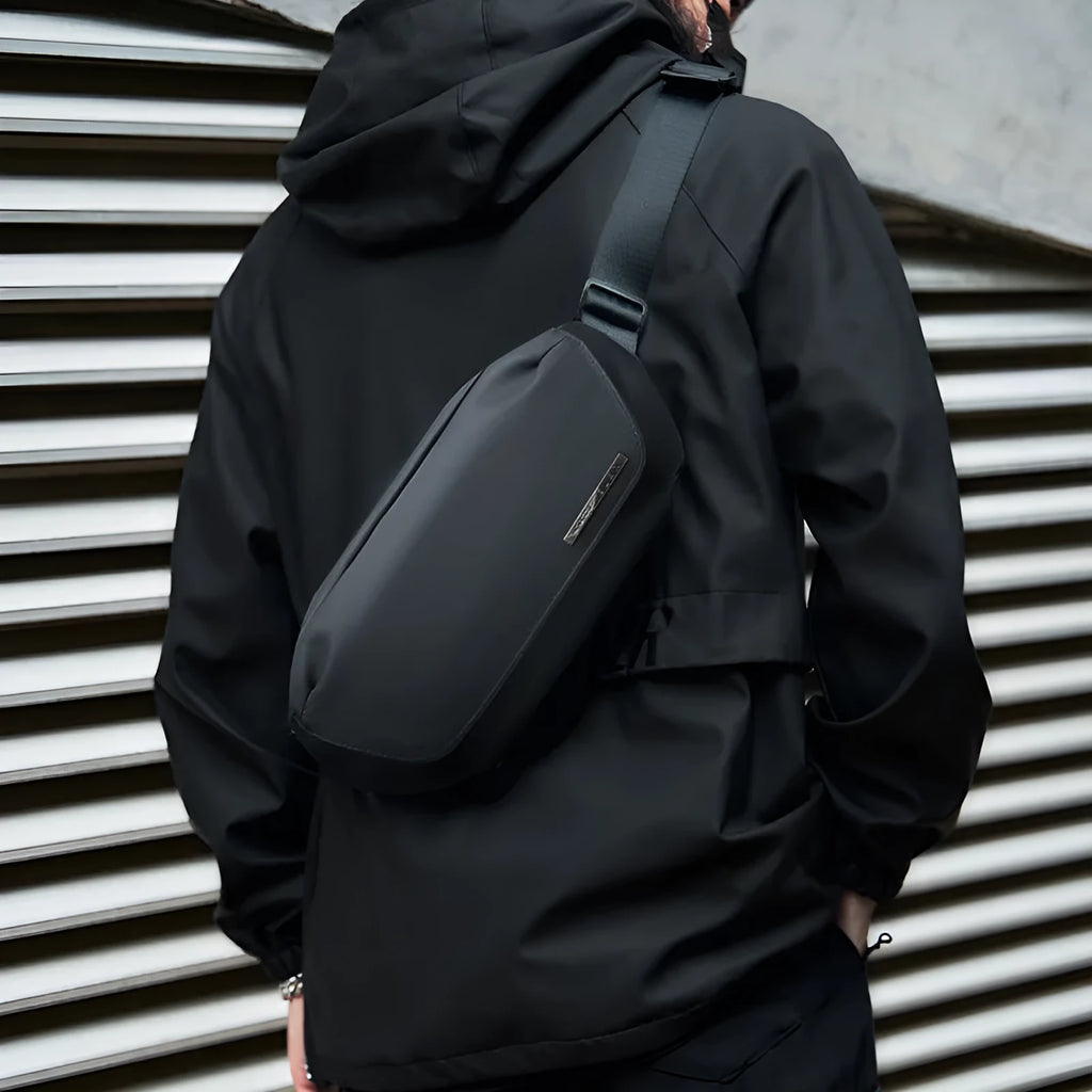 Black Oxford cloth messenger bag with one-shoulder riding design and street-style details