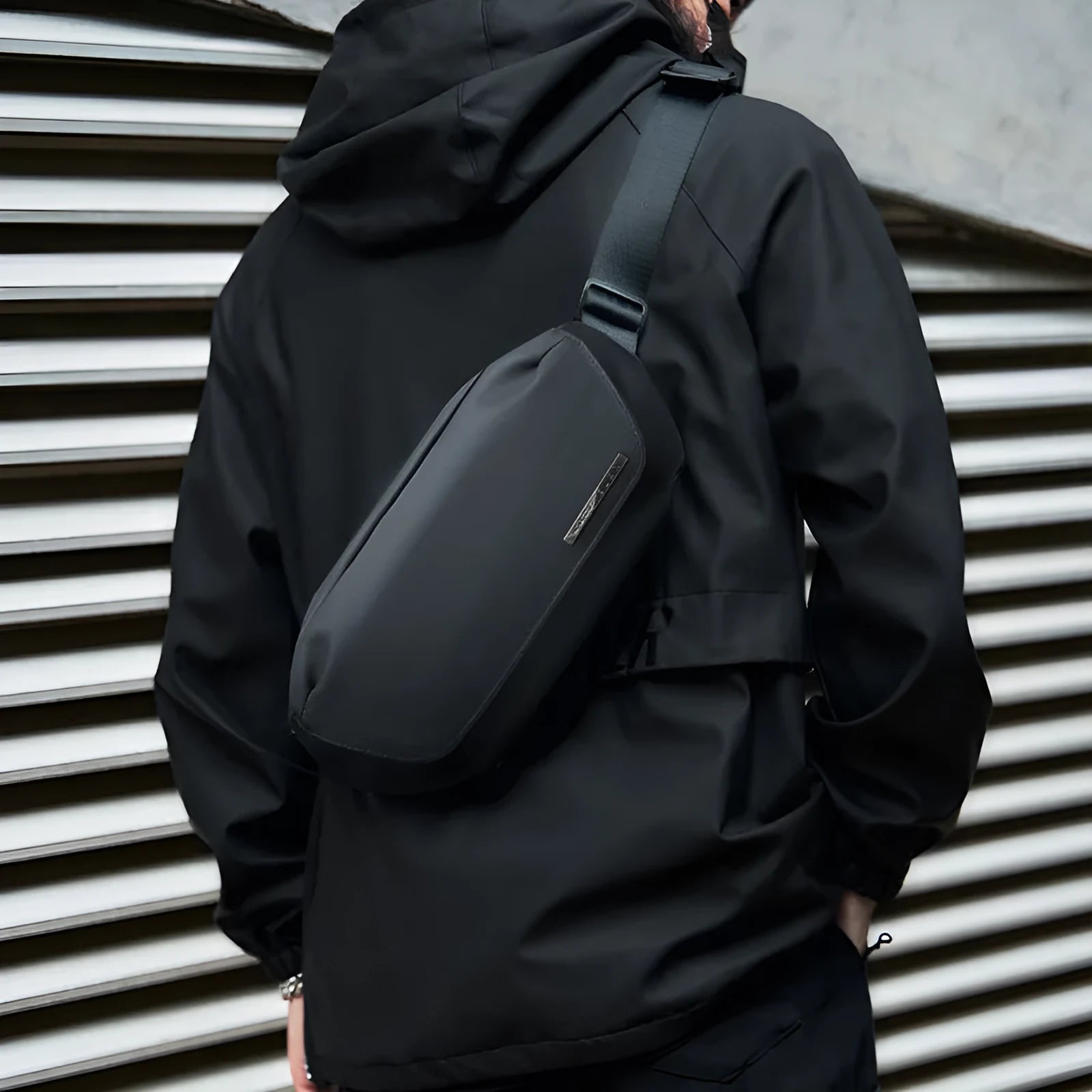 Black Oxford cloth messenger bag with one-shoulder riding design and street-style details
