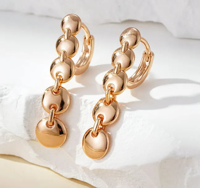 Gold retro woven hoop earrings showing full circle and textured copper surface