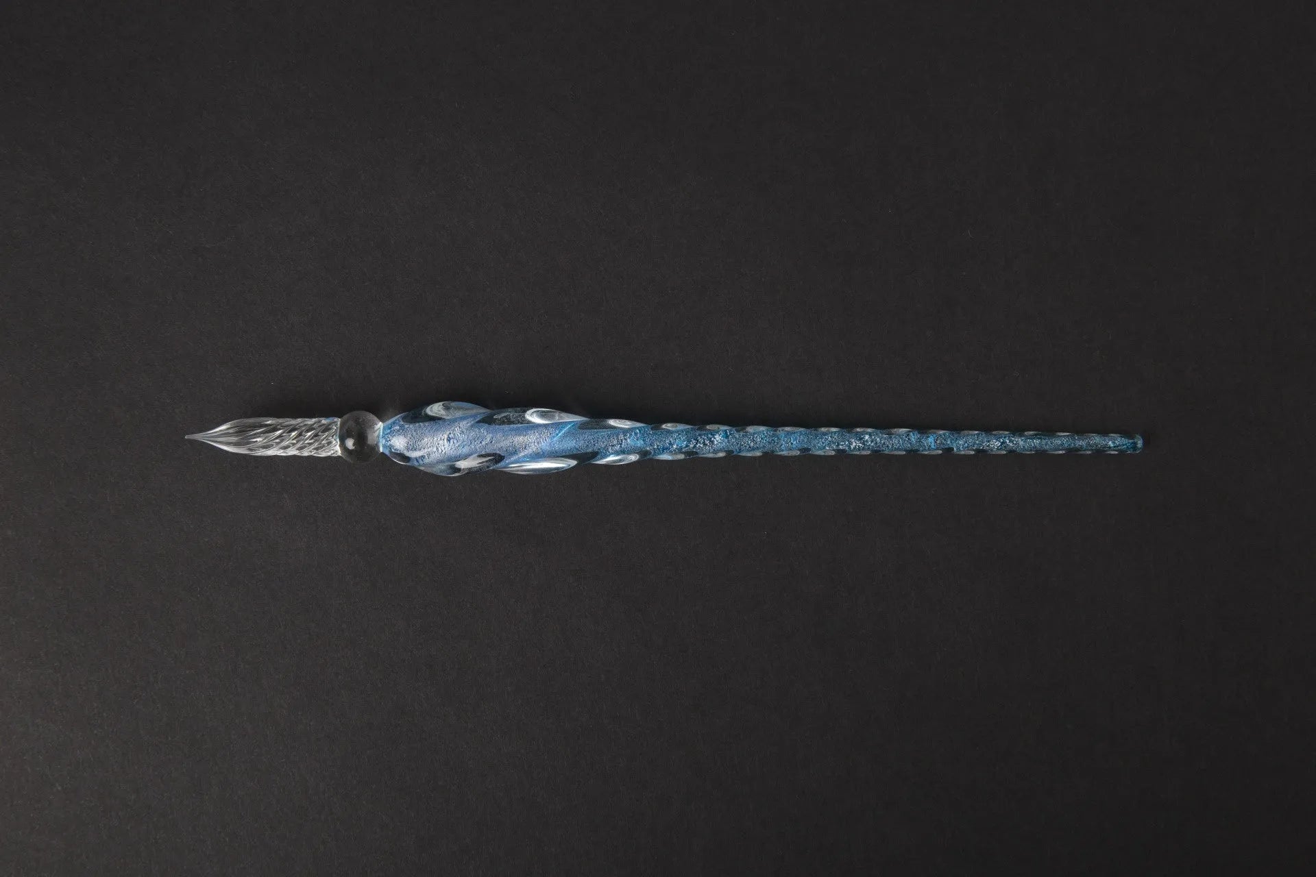 Transparent glass signature pen with coloured ink visible inside, abstract modelling, gift box packaging
