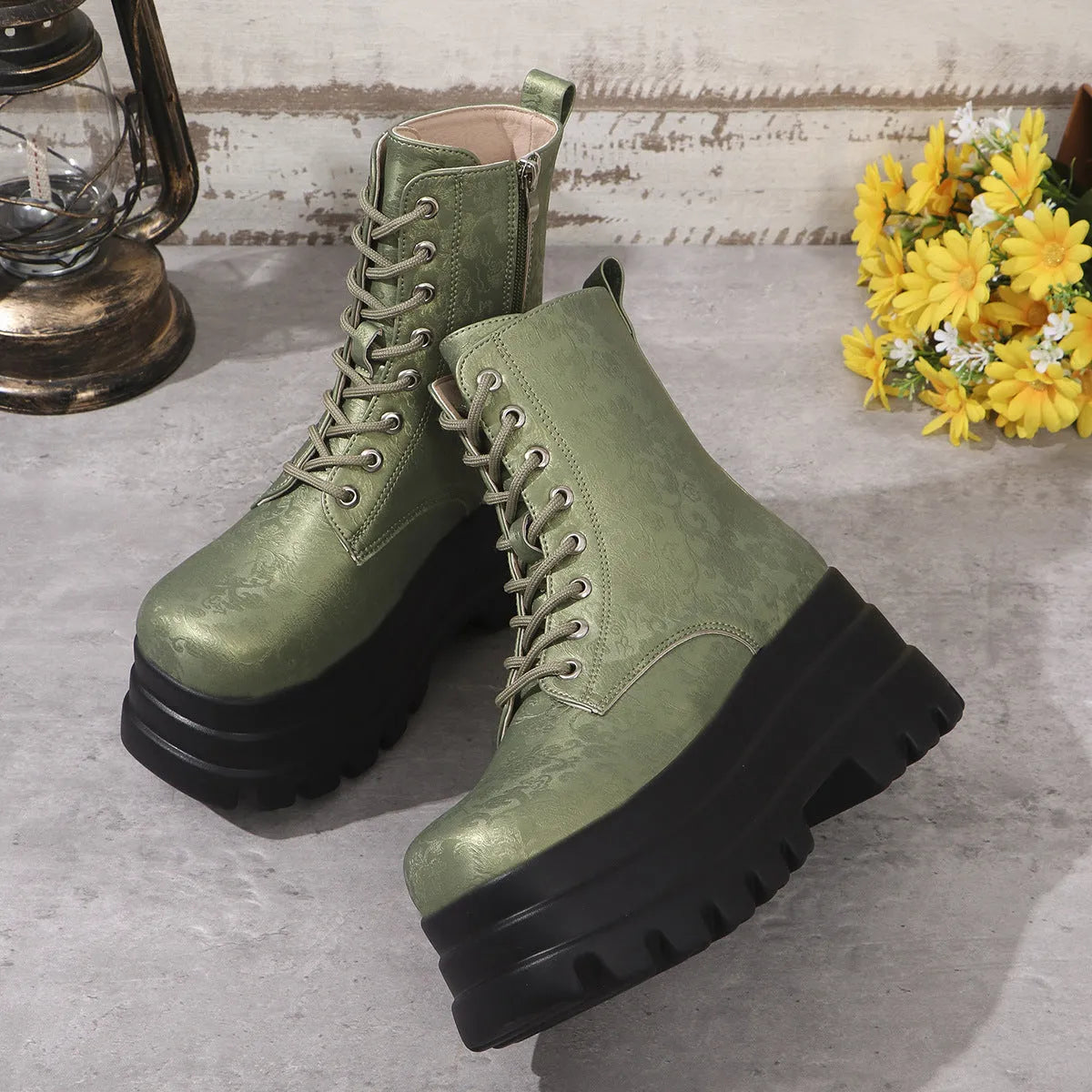 Women's black retro platform Martin boots with patchwork toe and side zip.