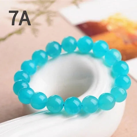Amazonite natural scattered beads in ice colour showing polished surface and hole drilling