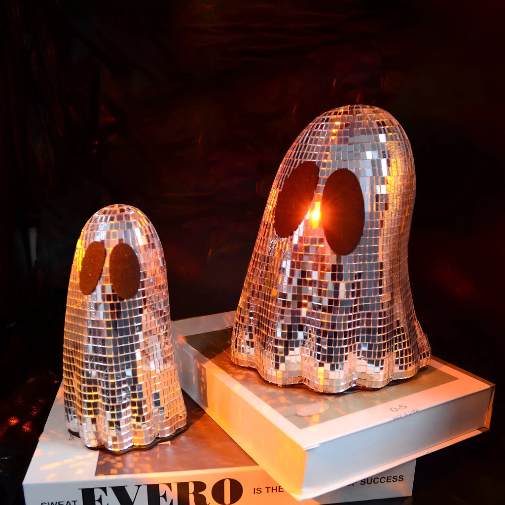 Silver Halloween ghost ornament with mosaic glass surface on wooden desk