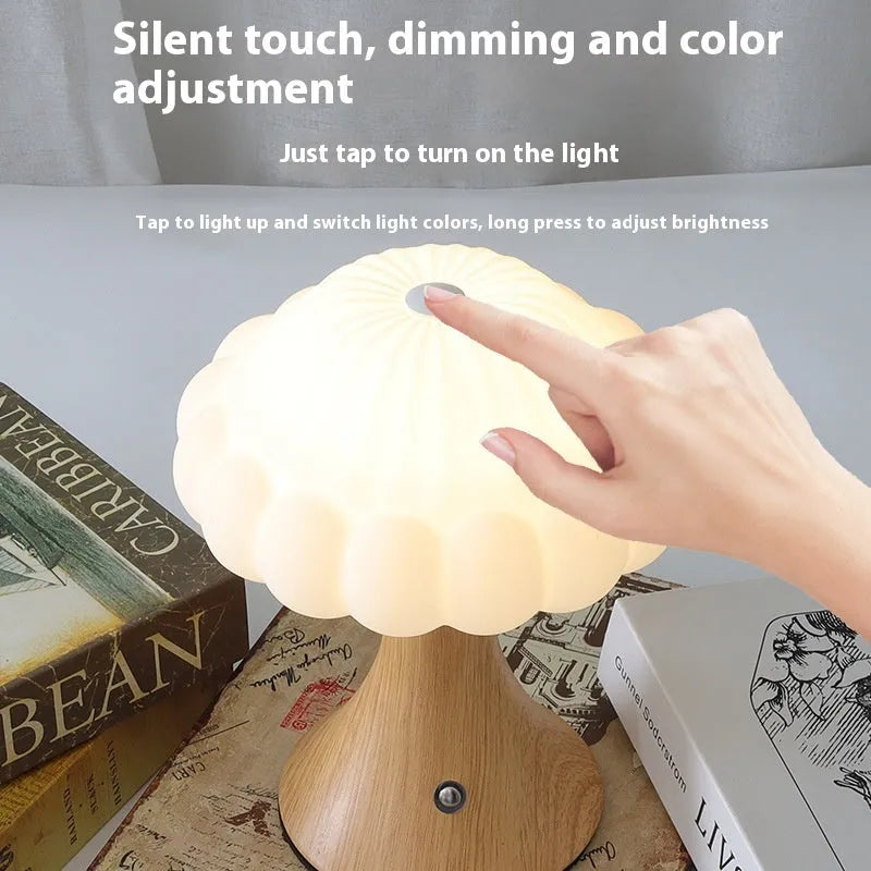 Small mushroom-shaped touch control night light in wood grain finish on a wooden table