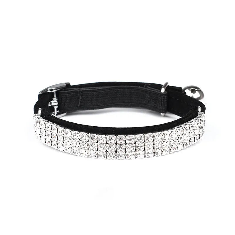 Adjustable velvet cat collar with rhinestones on a black background showing red, blue, and purple colour options.