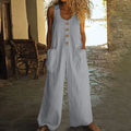 Sleeveless wide leg cotton jumpsuit in peacock green colour showing loose fit and pocket detail.