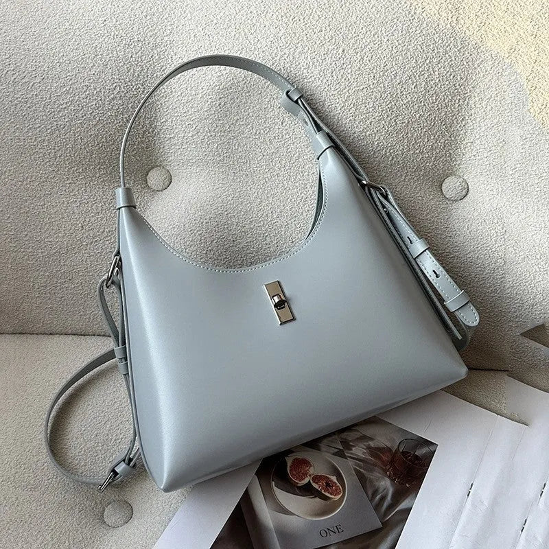 Genuine leather dumpling-shaped crossbody shoulder bag in apricot colour with a front sandwich pocket.