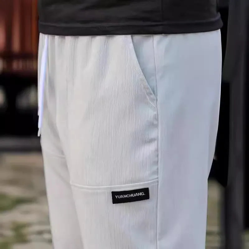 Men's polyester trousers for spring and autumn in light grey, available in sizes S to XXXL.