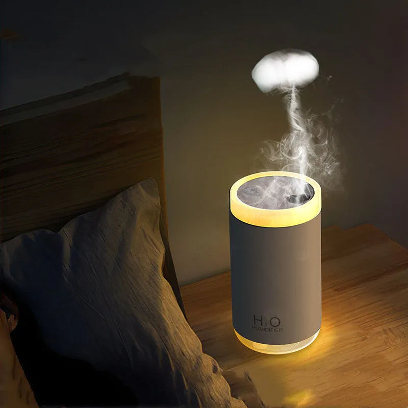 Blue jellyfish humidifier on a table emitting smoke ring mist with warm night light glow