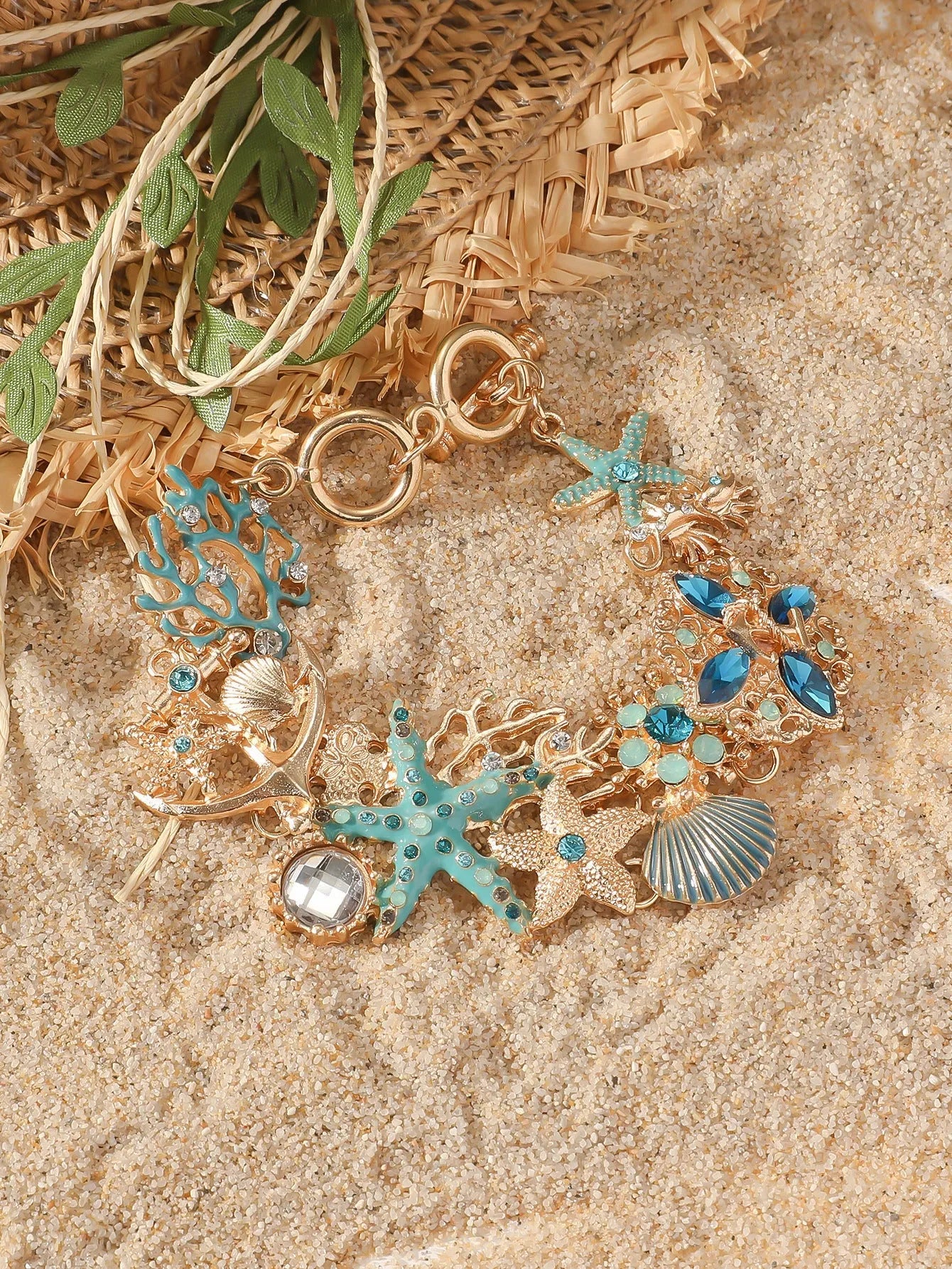 Alloy rhinestone starfish bracelet with boat anchor charm in blue, red, or turquoise.