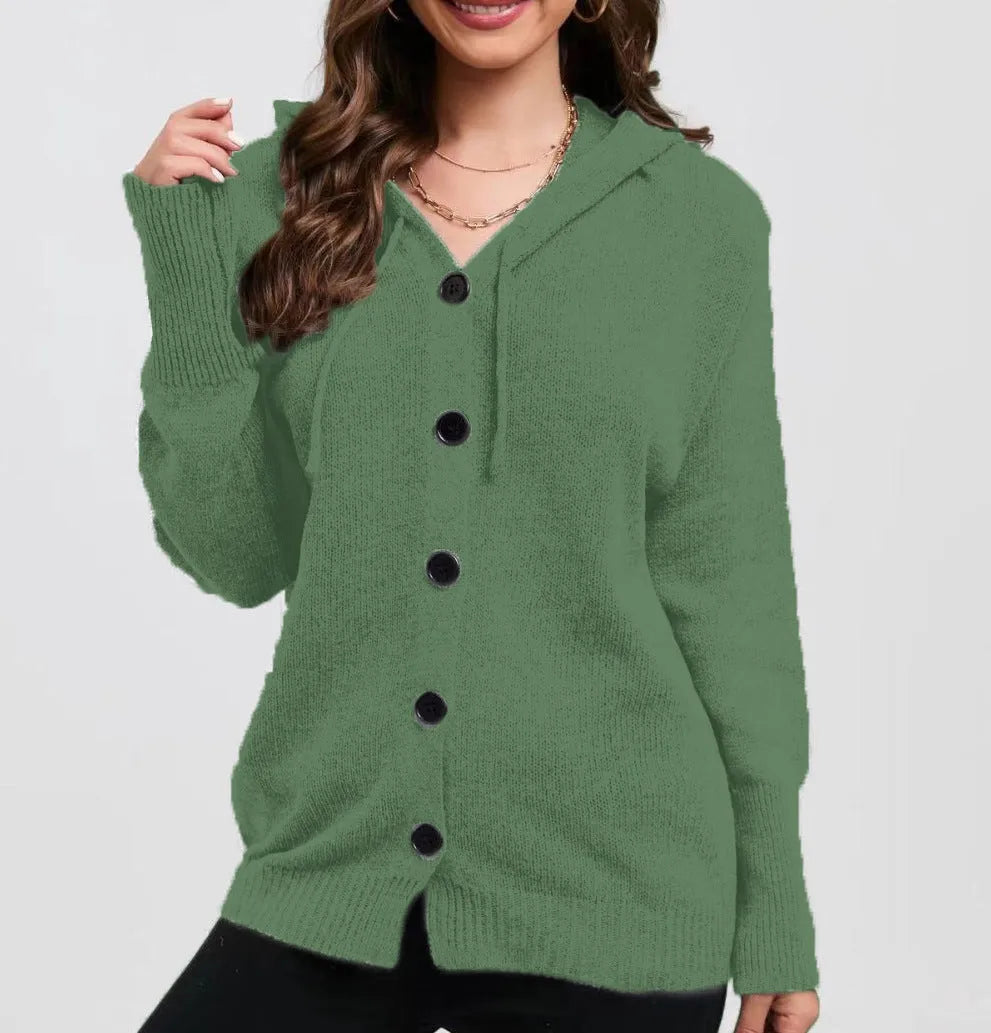 Woman wearing a thick army green zip-up hooded cardigan sweater with a loose fit.