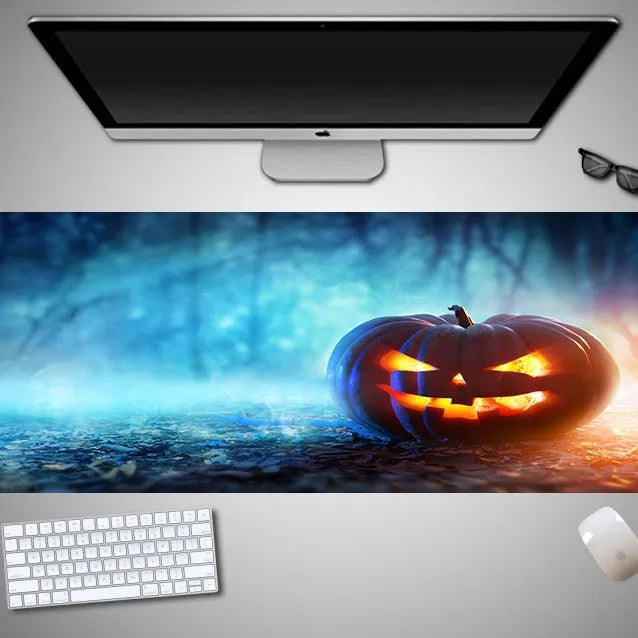 Large Halloween-themed computer mouse pad with graphic design on a desk