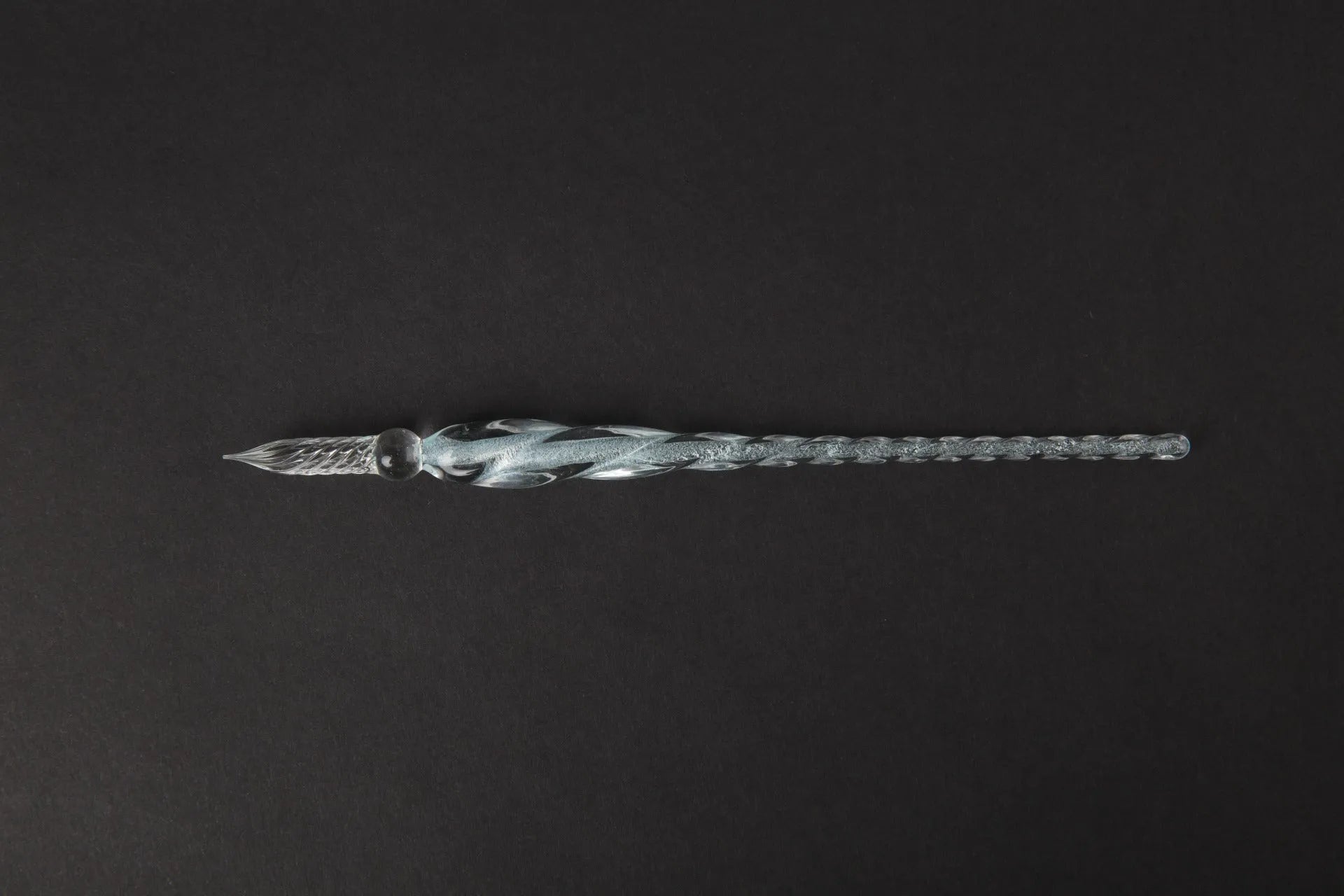 Transparent glass signature pen with coloured ink visible inside, abstract modelling, gift box packaging