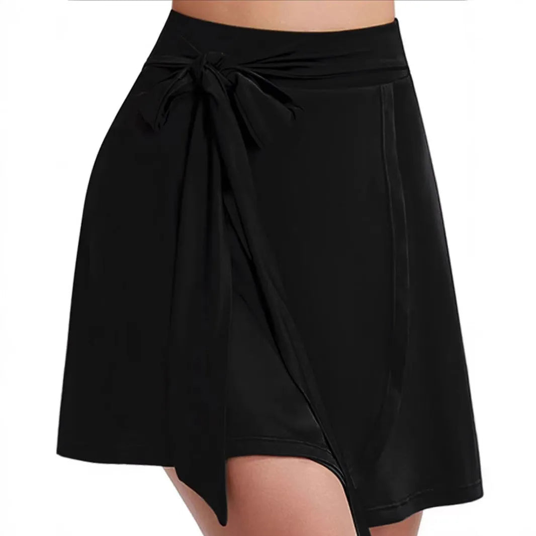 Black thigh-length unisex sports skirt with built-in shorts, high waist, and culotte style.