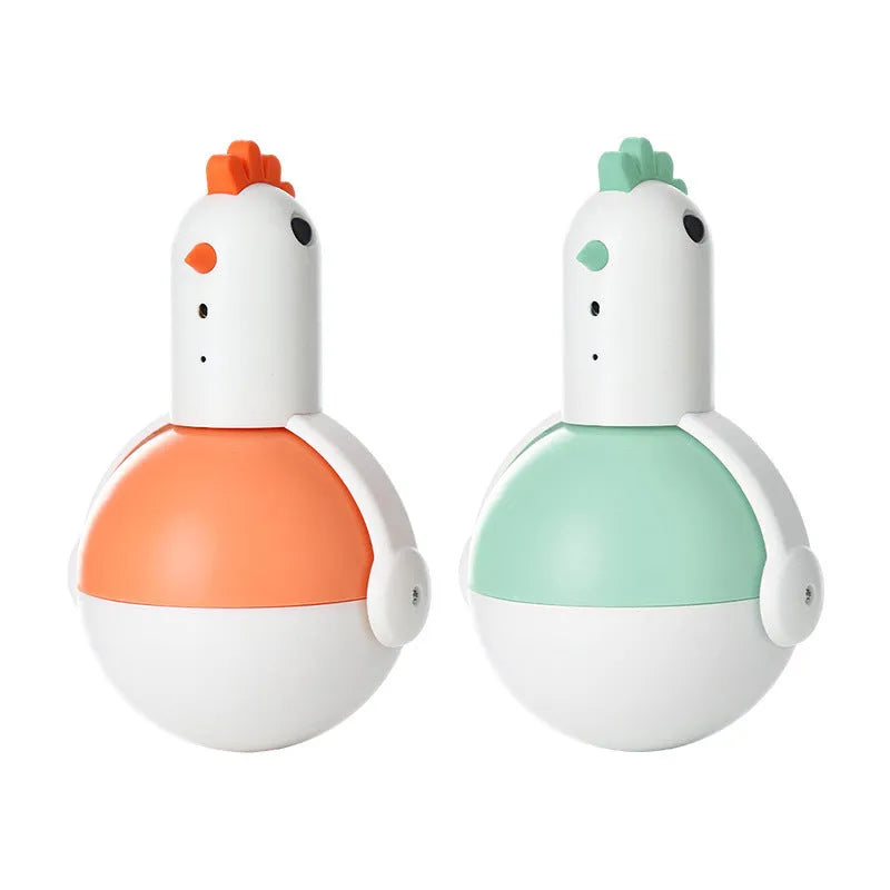 Green or orange electric chicken-shaped cat toy with laser and sound features on a flat surface.