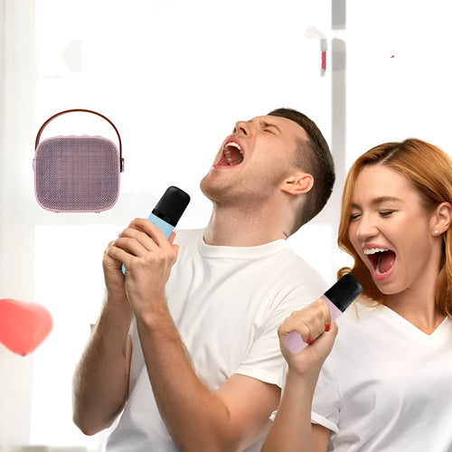 Small white portable Bluetooth speaker with a built-in microphone on a table.