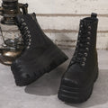 Women's black retro platform Martin boots with patchwork toe and side zip.