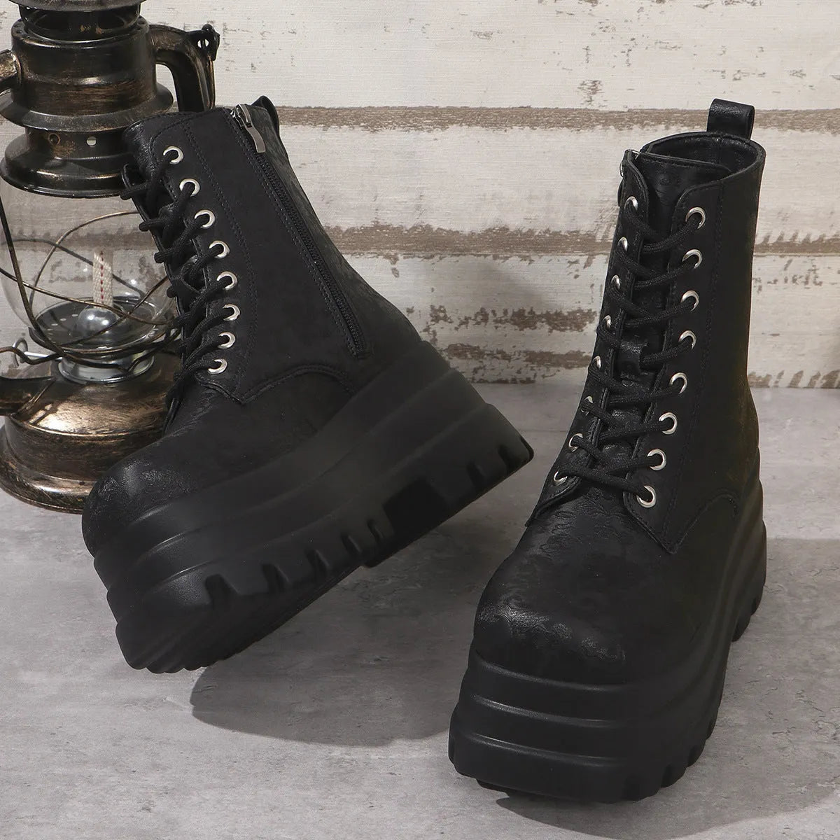 Women's black retro platform Martin boots with patchwork toe and side zip.