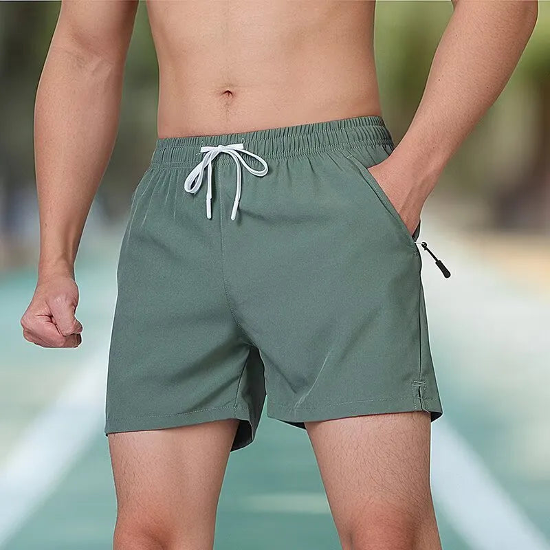 Man wearing black high-waisted Ice Silk polyester fitness shorts for running or gym training.