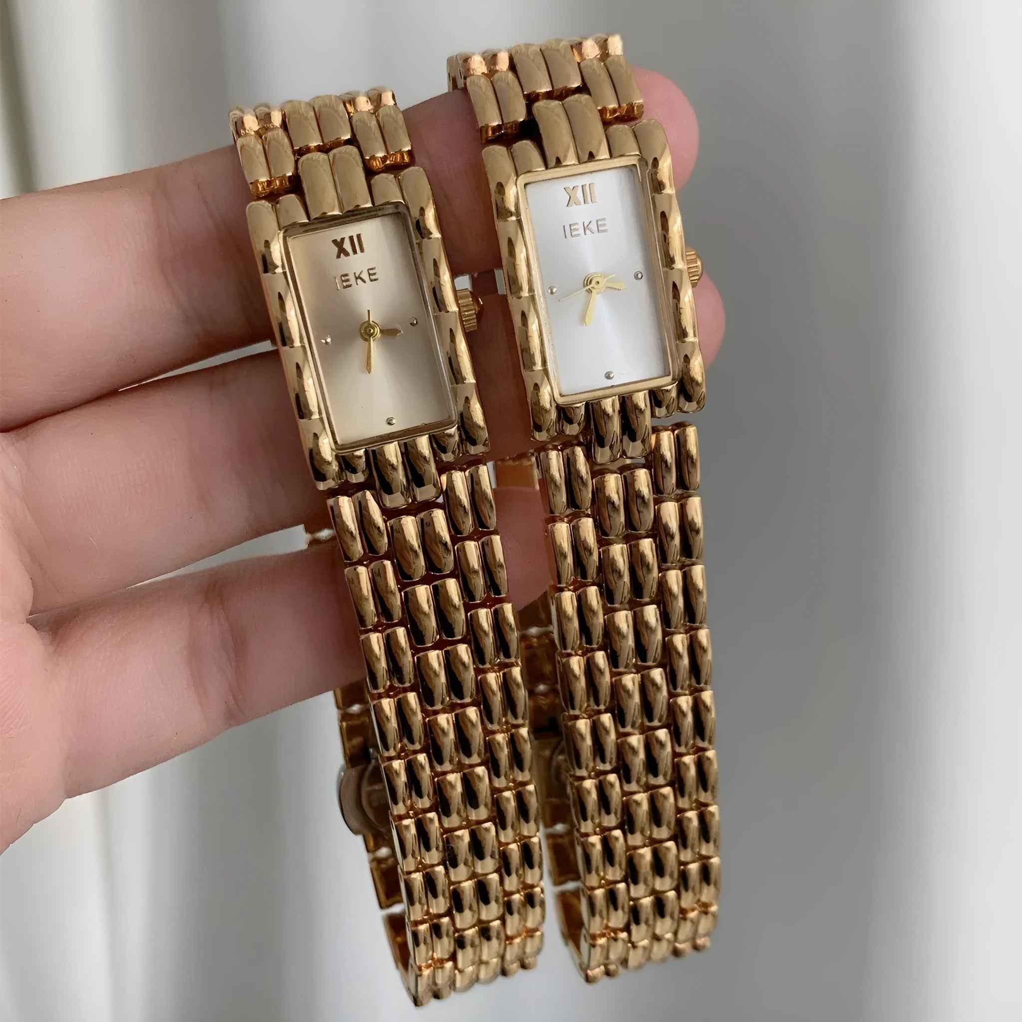 Women's bracelet-style watch with 15mm dial, mineral glass, and butterfly buckle in silver or gold finishes