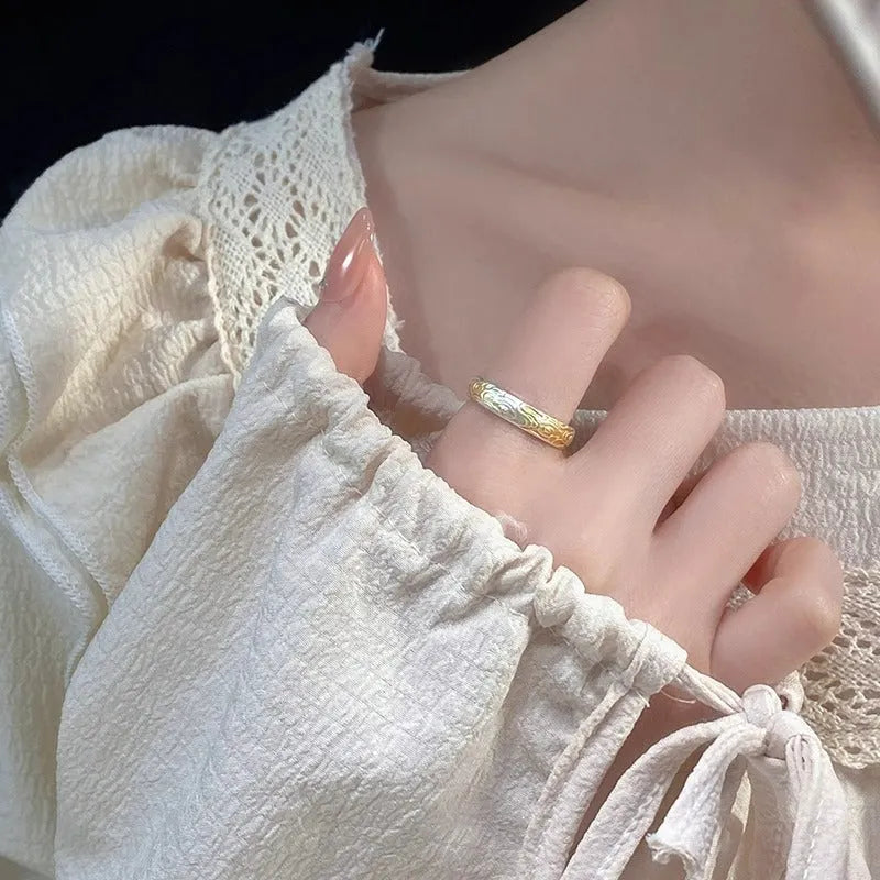 Geometric xiangyun pattern open mouth ring in silver electroplated finish on white copper.
