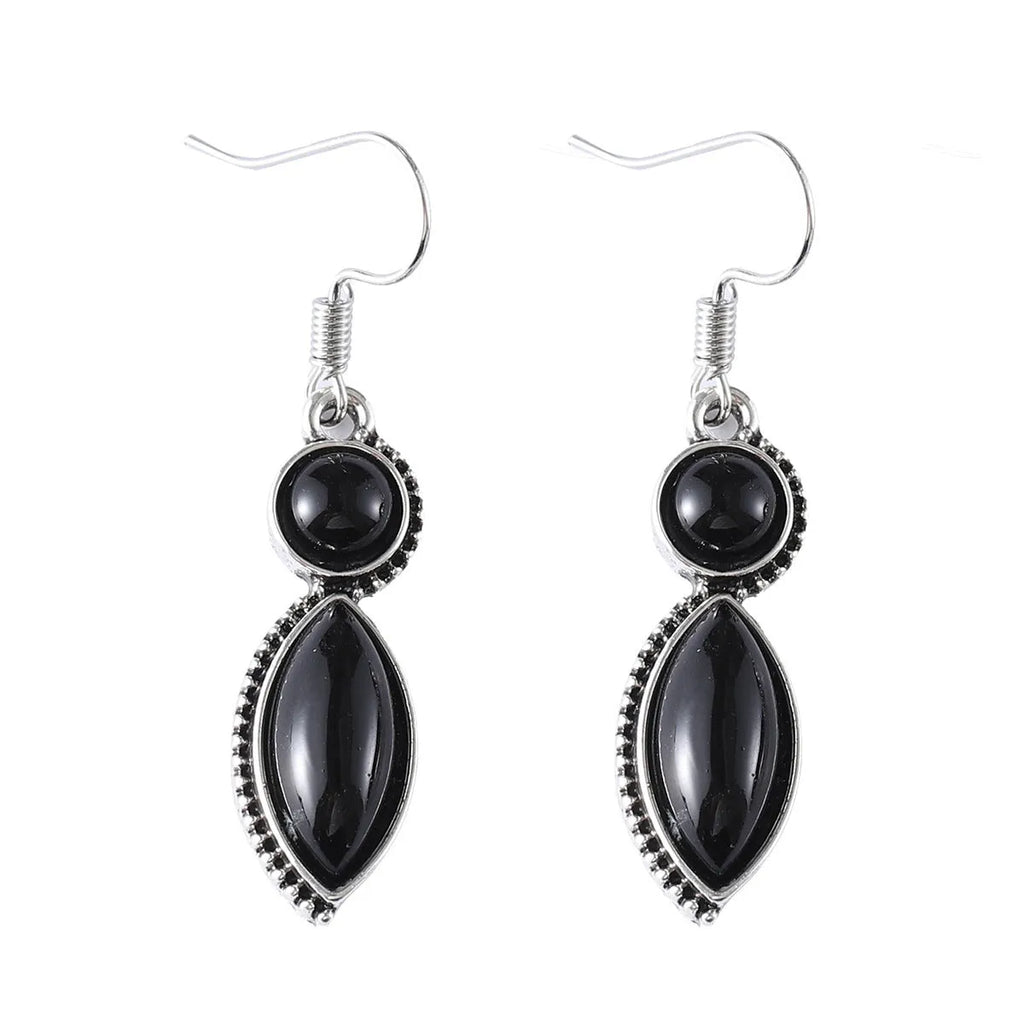 A pair of black and purple vintage geometric pendant earrings with bohemian style on a white background.