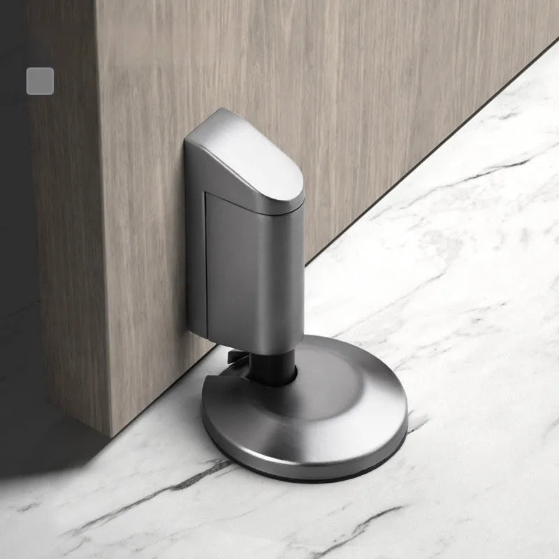Modern invisible zinc alloy door stopper in six colour finishes on a wall.