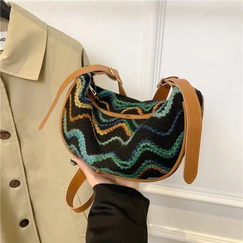 Women's straw woven crossbody bag showing knitted weaving texture and internal phone pocket