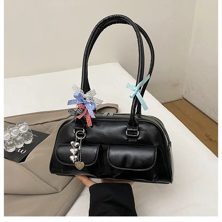 Retro brown PU leather women's pillow handbag with a flap and double shoulder strap on a neutral background.