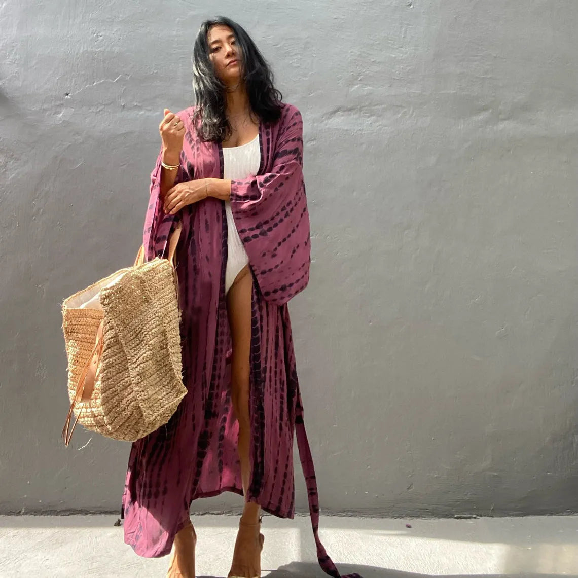 Woman wearing a printed cotton beach cover-up blouse in a DN0712 series colour.