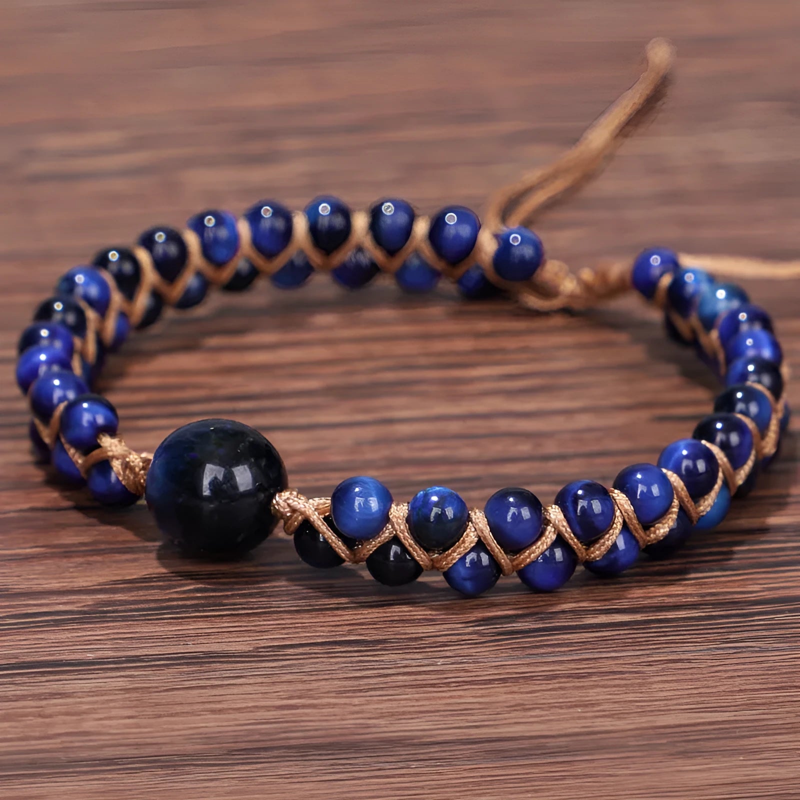 Handmade woven geometric pull bracelet in blue tigereye stone with adjustable closure.