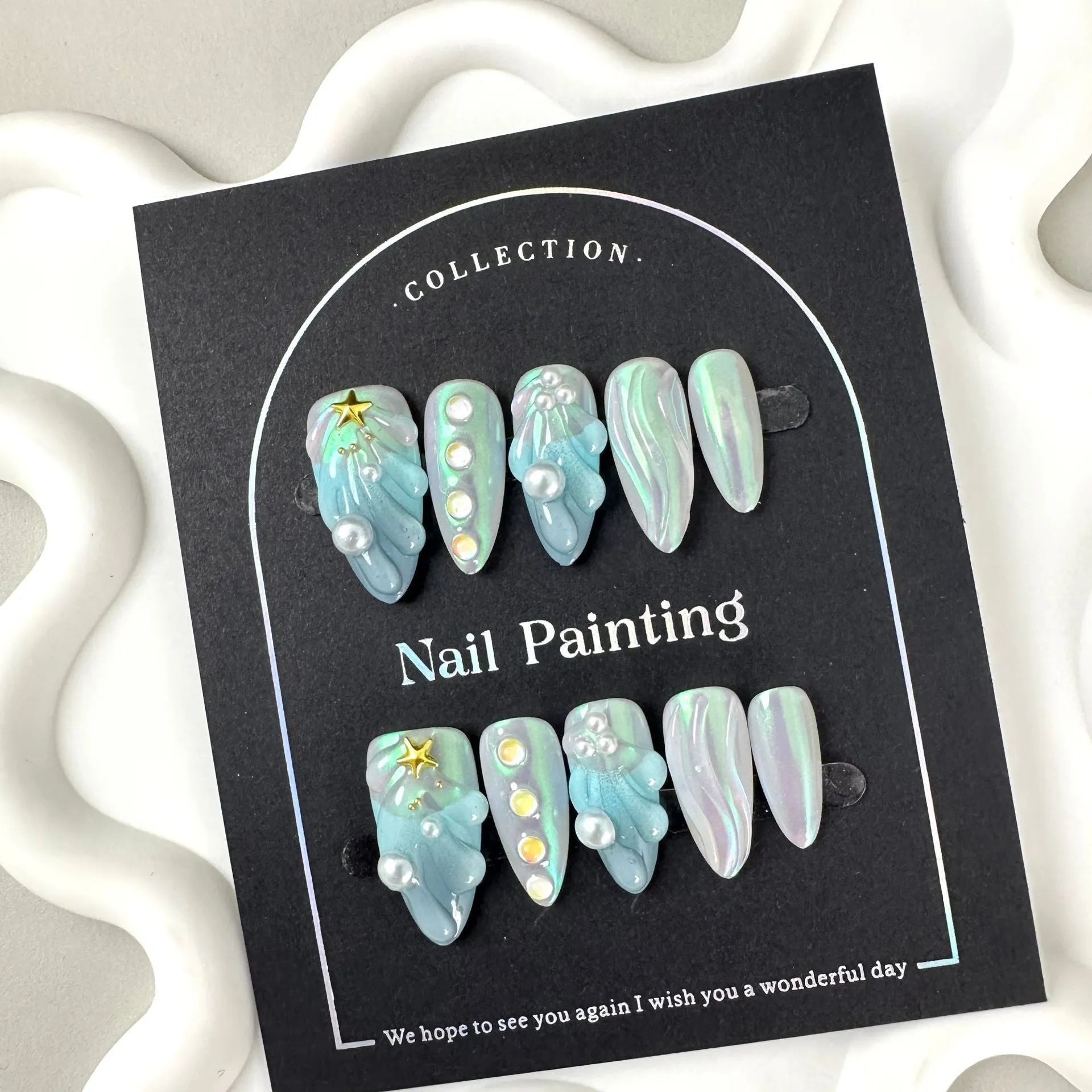 Blue plastic artificial nail tips laid out showing sizes XS S M L