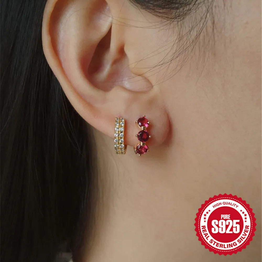A pair of 925 sterling silver earrings with a geometric sunflower design inlaid with golden zircon stones.