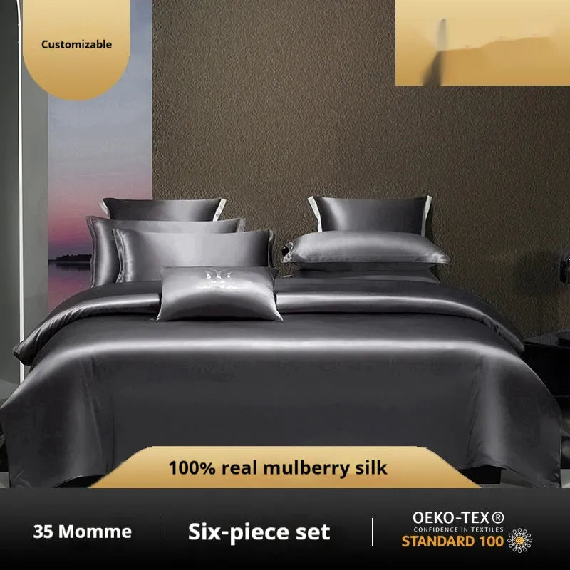 Silk four-piece quilt cover set in a solid colour, shown in a bedroom setting on a bed.