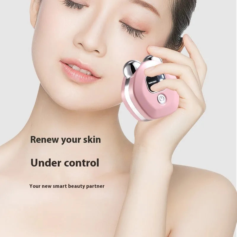 Portable white facial massage instrument with a dual-roller head for hot compress and microcurrent therapy.