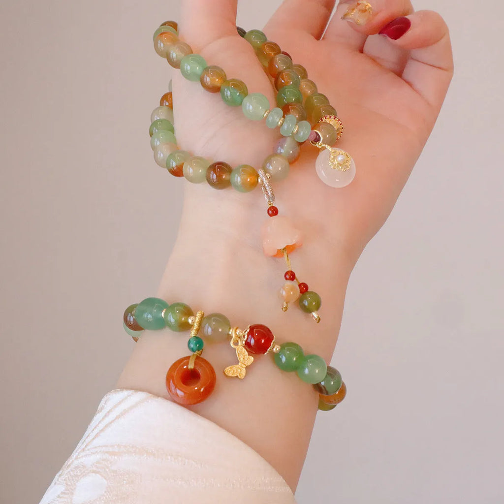 Natural peacock green agate bracelet with 8mm beads and butterfly peace buckle on white background