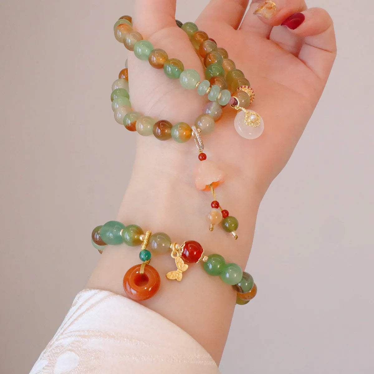 Natural peacock green agate bracelet with 8mm beads and butterfly peace buckle on white background