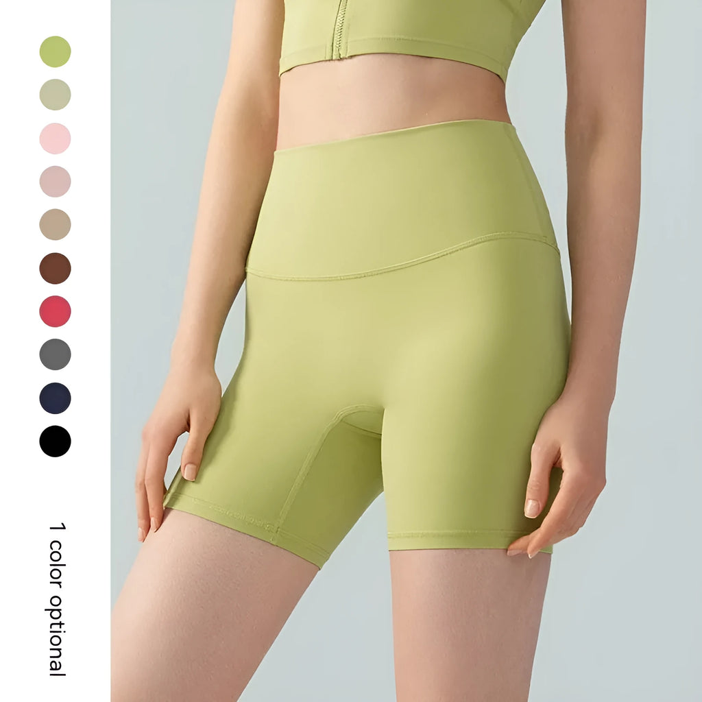 Women's high waist Lycra yoga shorts in leaf green, shown in a yoga pose.
