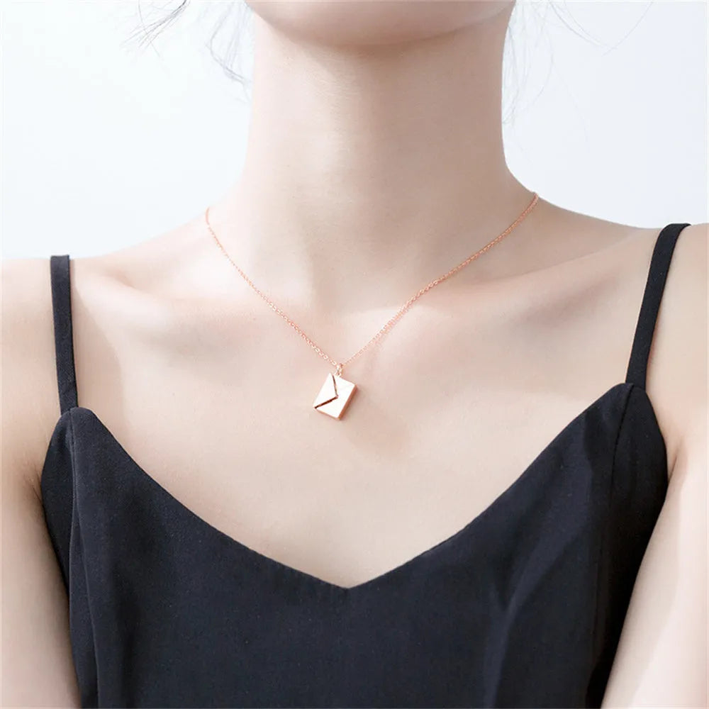 Gold envelope-shaped locket pendant on a stainless steel chain with custom engraving option