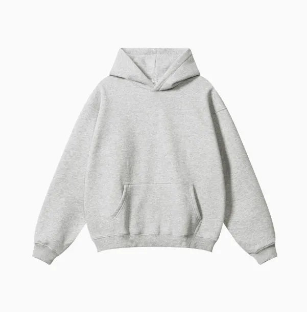 Man wearing a loose-fit cotton terry hooded sweater with drop-shoulder sleeves in a solid colour.