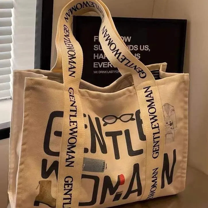 Women's large canvas tote bag with printed design options for travel and shopping.