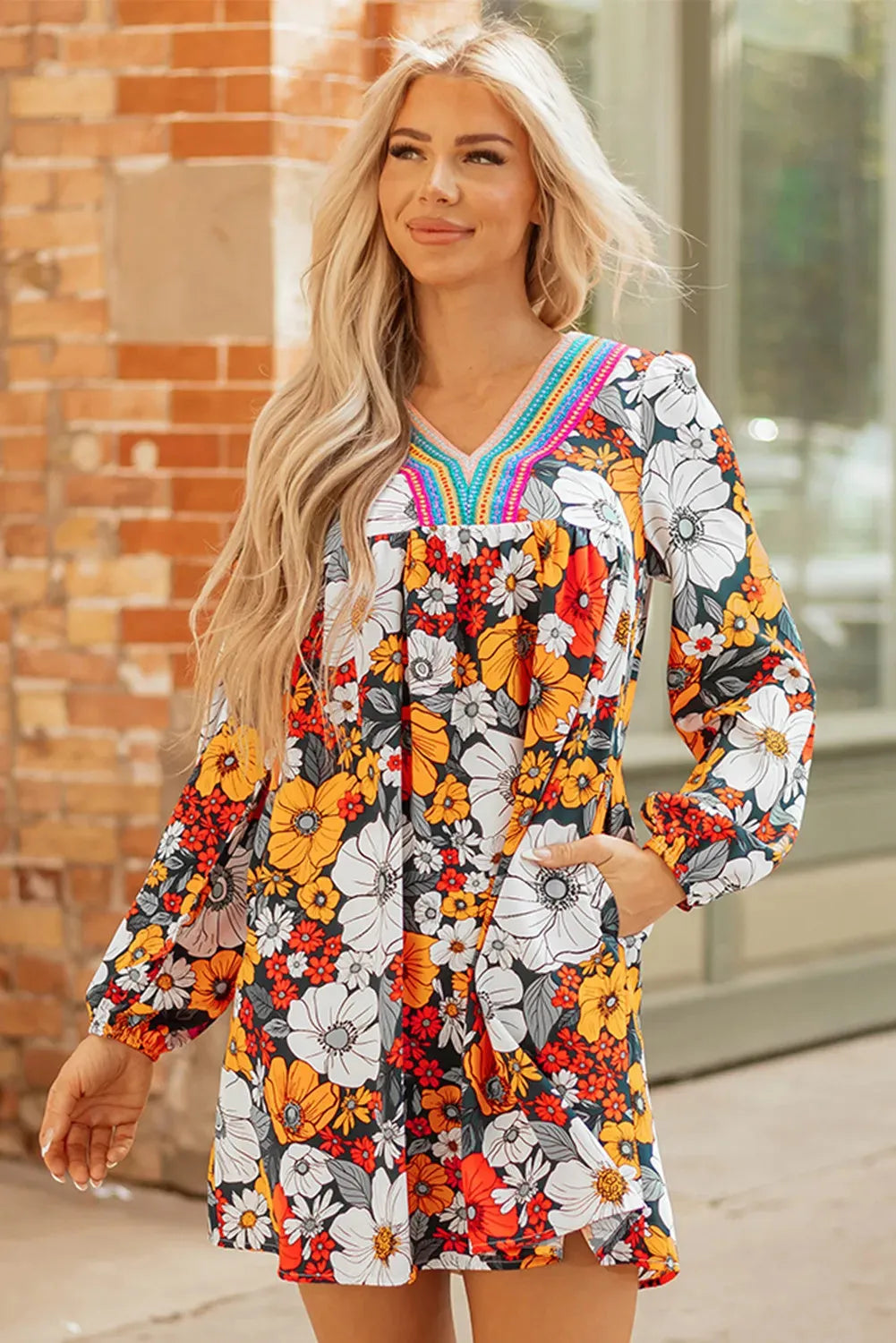 Orange floral print mini dress with striped and lace long sleeves and a V neckline.