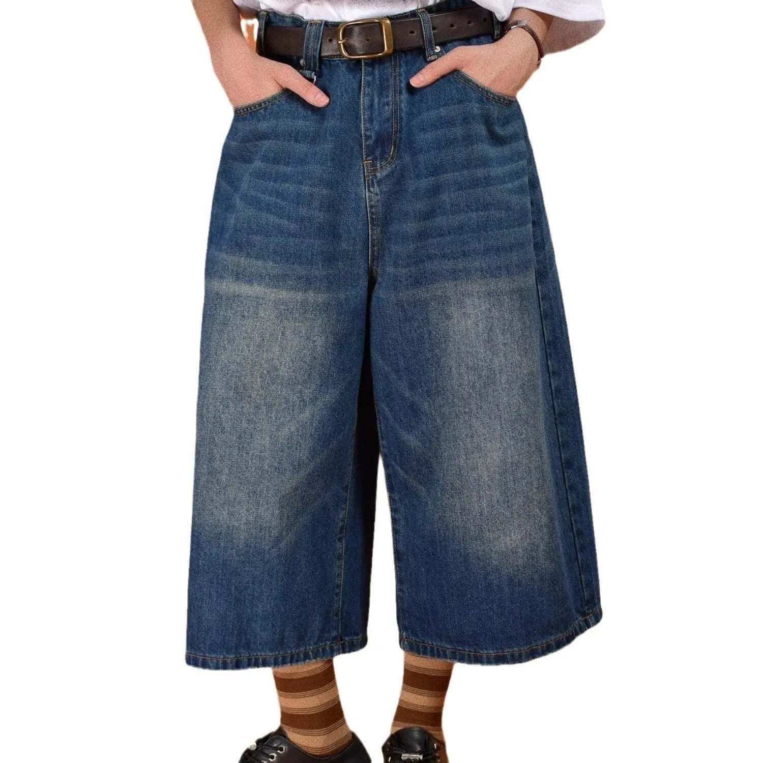 Men's loose fit jeans shorts in blue denim with a straight leg, shown on a model.