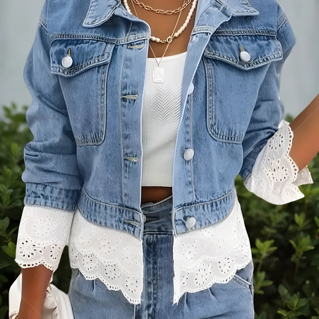 Blue women's denim jacket with lace stitching detail on the sleeves and front, featuring long sleeves.