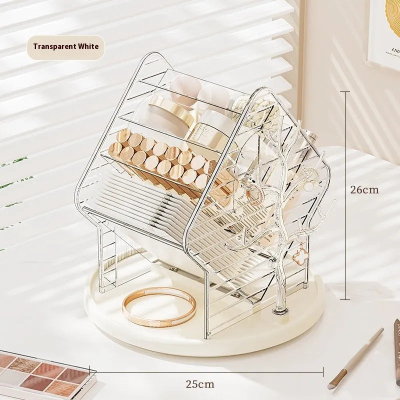 Rotating multi-tiered cosmetics storage box in clear transparent plastic on a wooden surface.