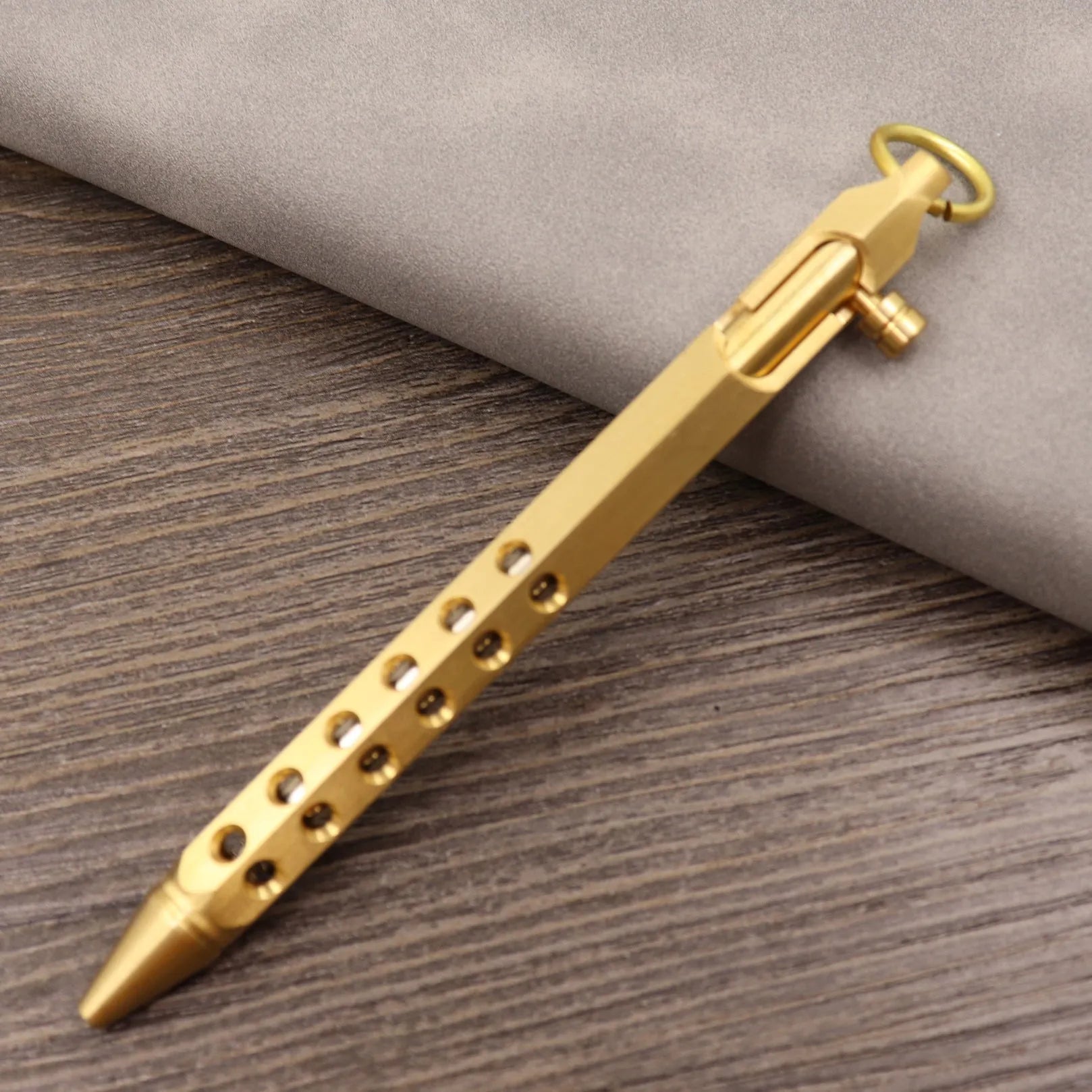 Retro brass tactical pen with press bolt-action mechanism and cylindrical metal barrel