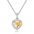 Women's sterling silver necklace with heart-shaped pendant containing natural gemstone on adjustable cross chain