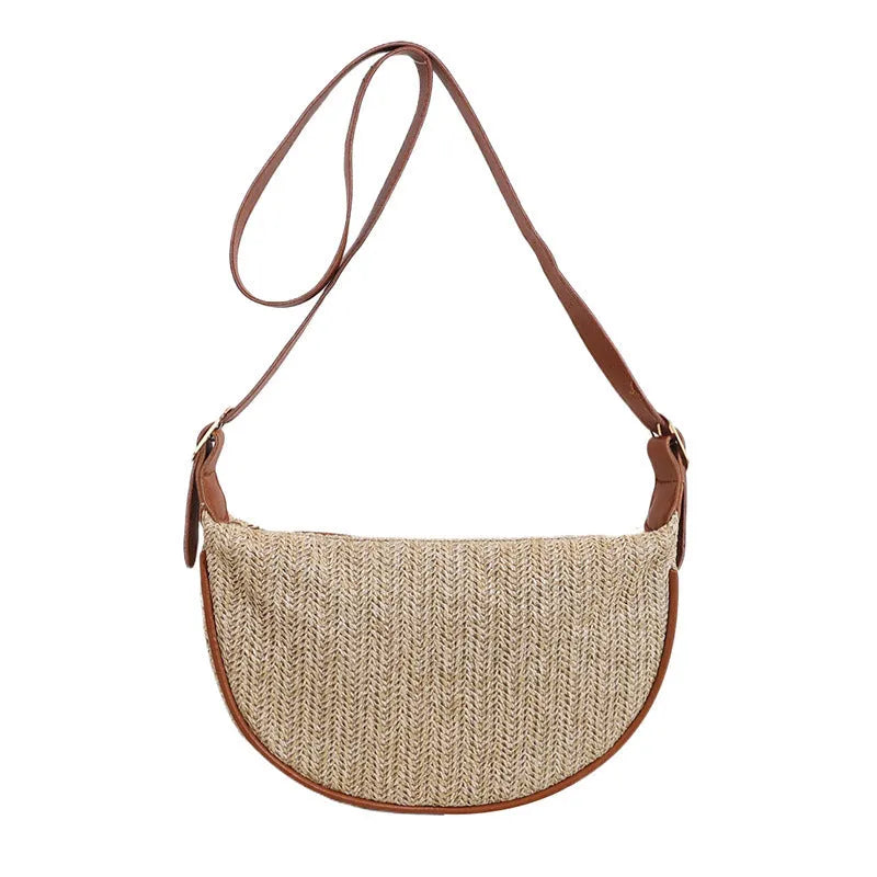 Women's straw woven crossbody bag showing knitted weaving texture and internal phone pocket