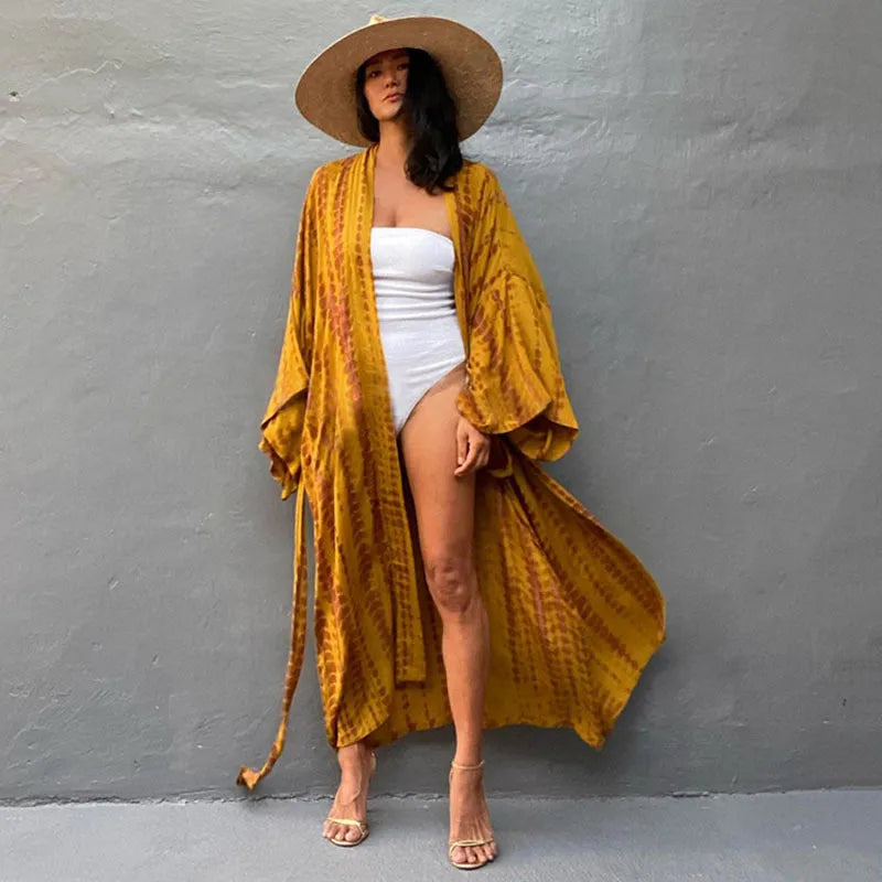 Woman wearing a printed cotton beach cover-up blouse in a DN0712 series colour.