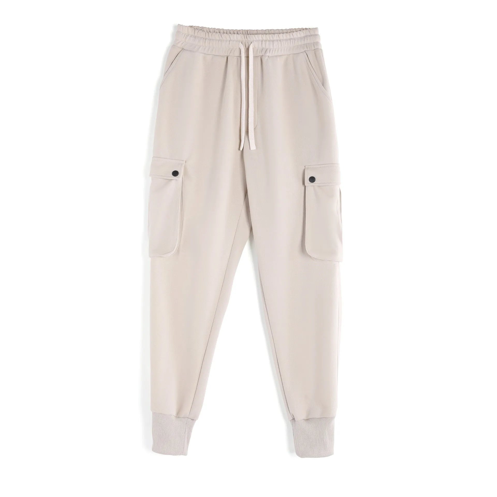 Man wearing loose light grey cotton trousers with ankle tie and multiple pockets, style of American sports leisure wear.